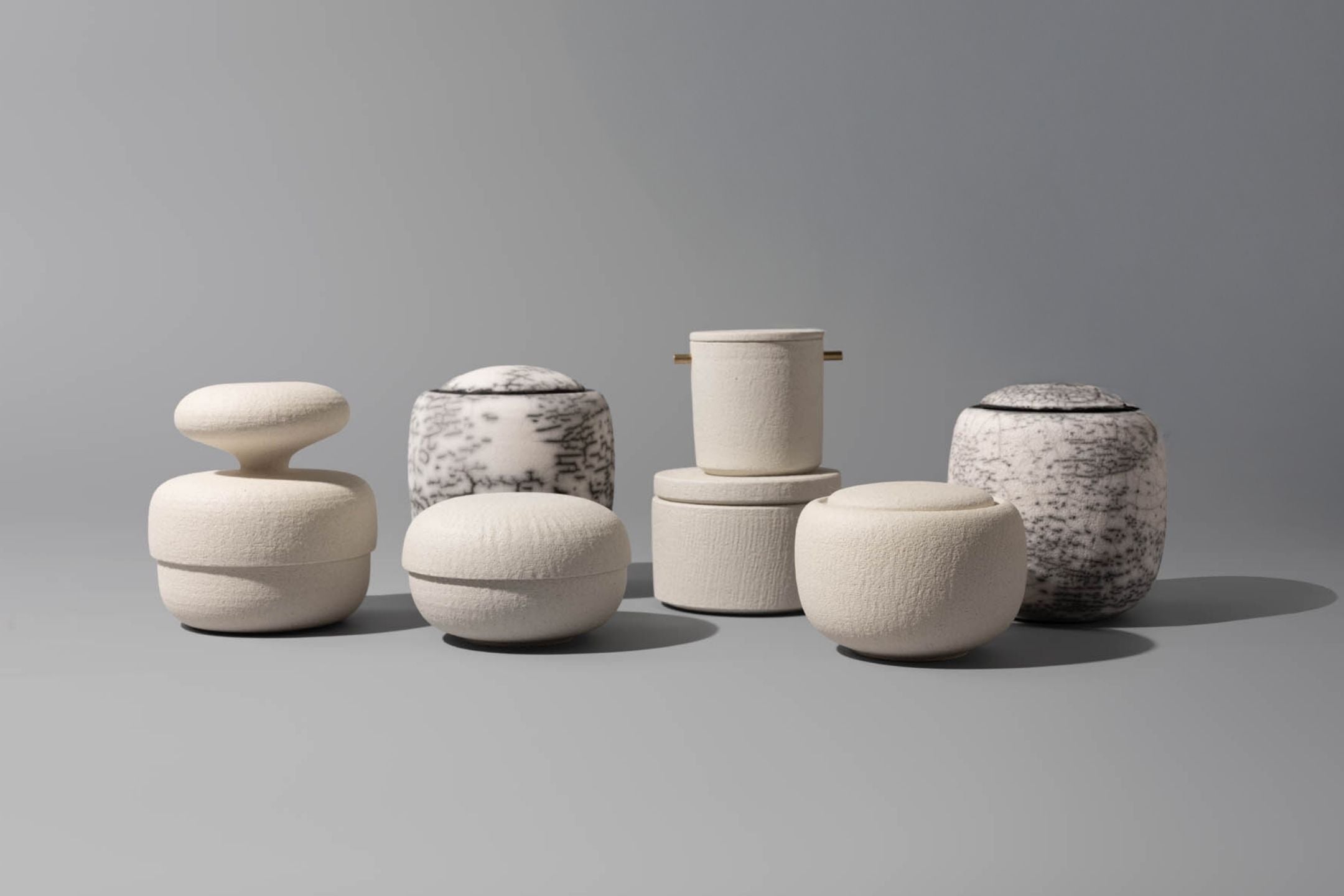 Selection of beautiful Vaso ceramic cremation urns on a grey background