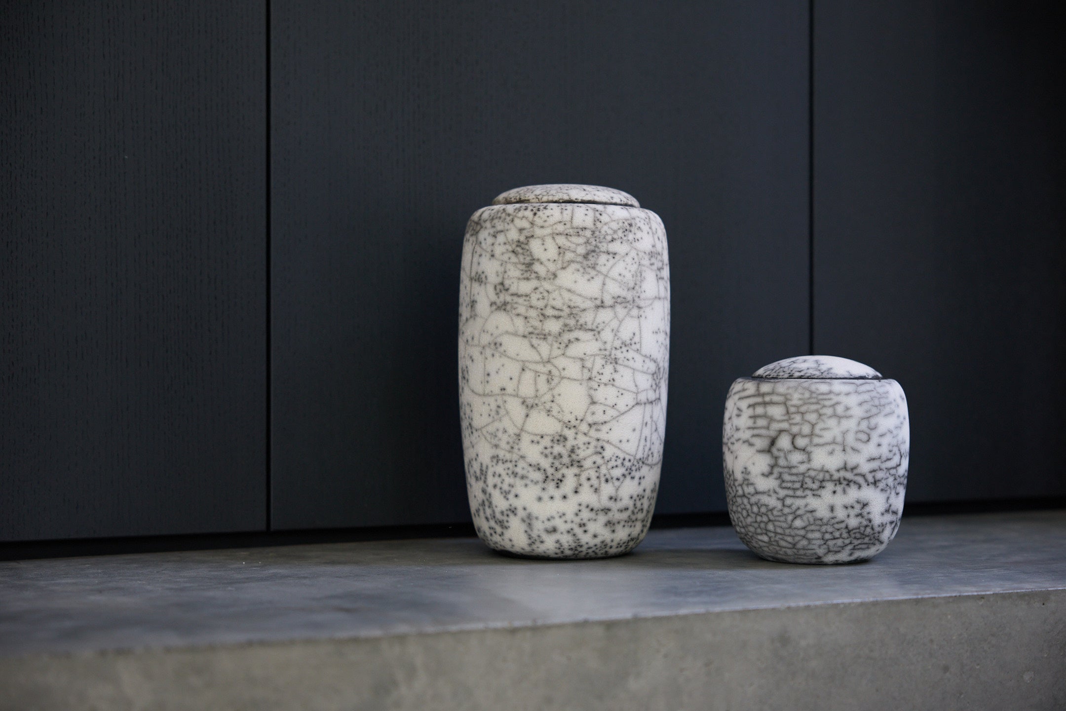 Two of Vaso's beautiful handcrafted, raku-fired Cygnus cremation urns.